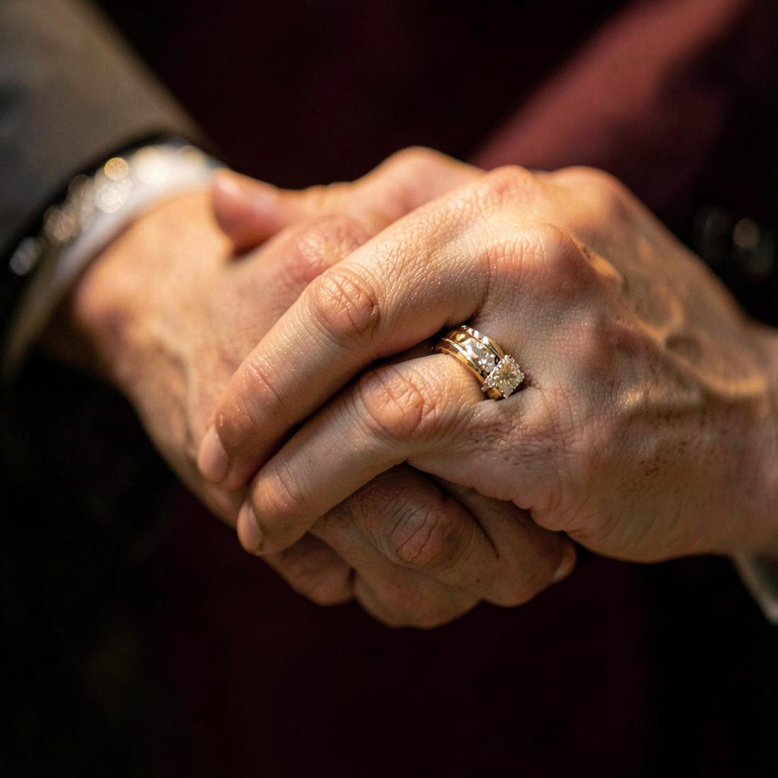 Hands together with rings